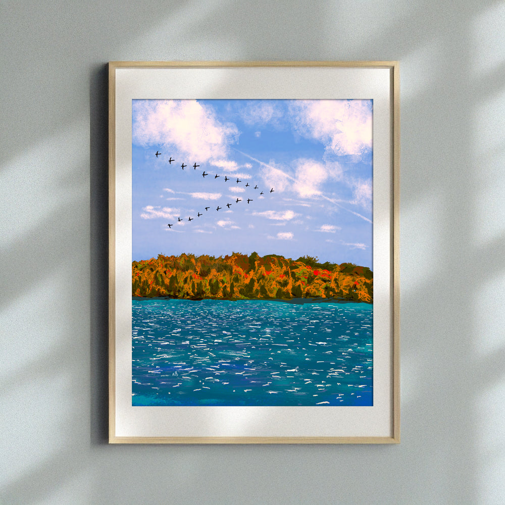Framed print of a Nathan Gowsell Creative art piece called A Skein of Geese, hung on a wall with a vase of white flowers in the foreground.