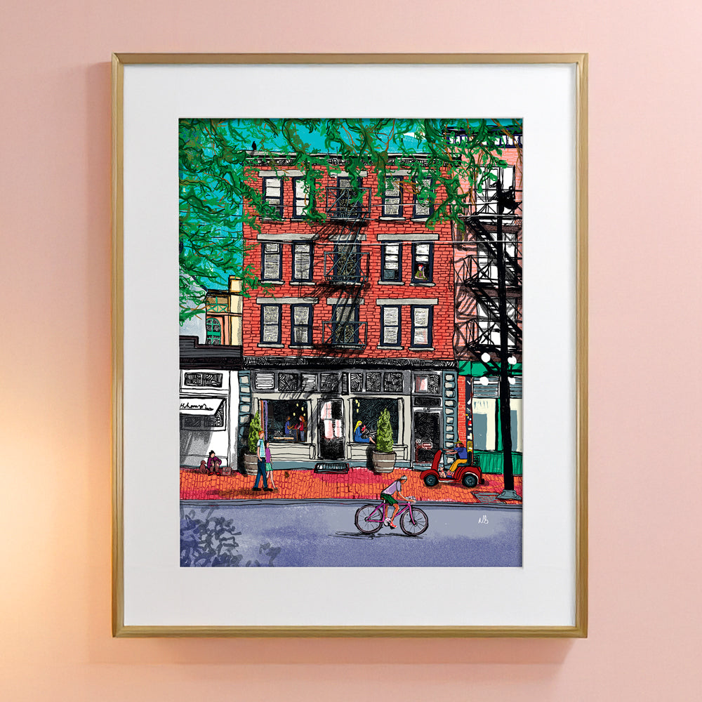 The City is Alive Artwork by Nathan Gowsell Creative framed and hung on a peach wall. 