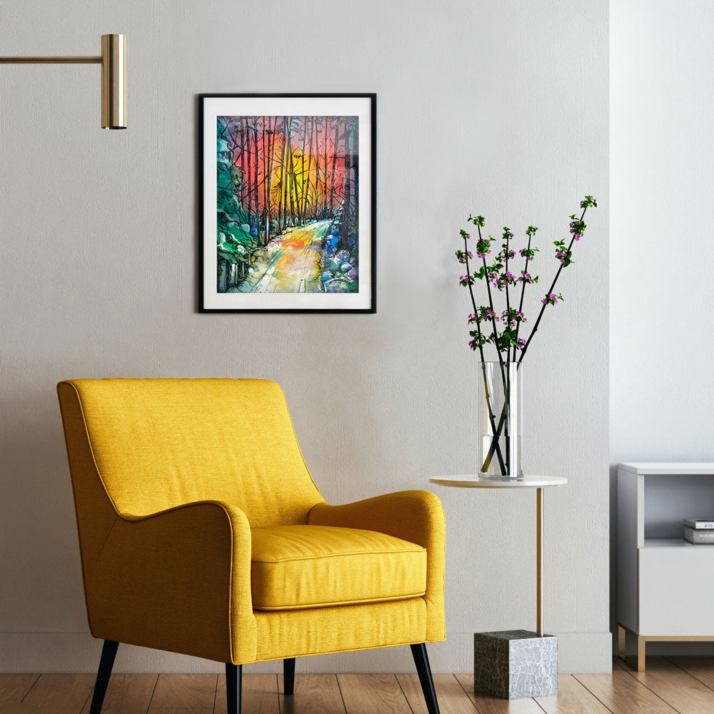 Winter art print framed on wall above yellow chair